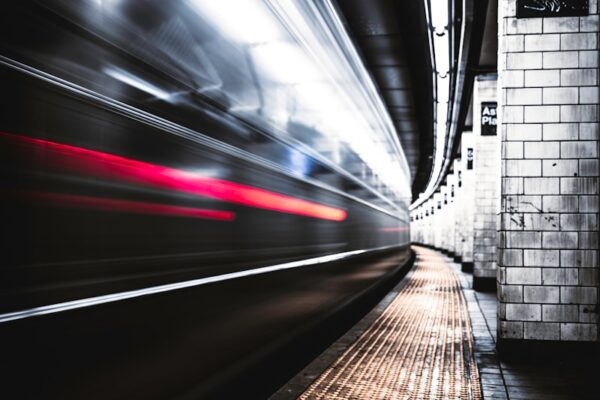 time lapse photography of train in tunnel
