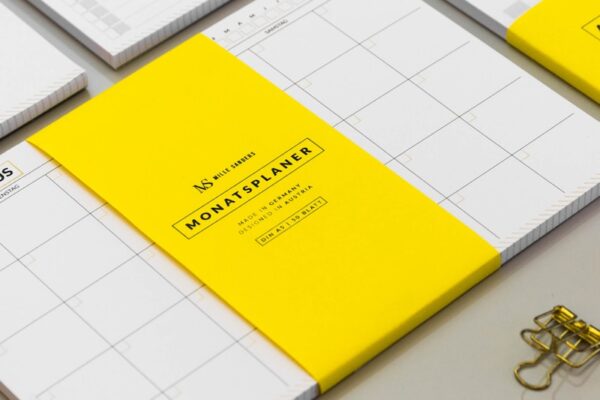 a group of yellow and white binders sitting on top of a table