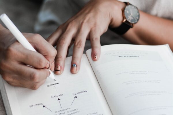person writing on book